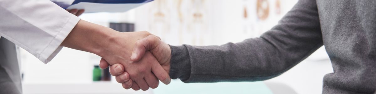 Detail of handshake of doctor and patient.