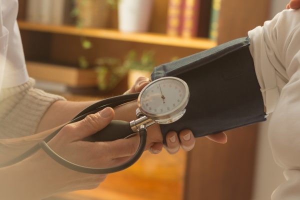 Older female patient when measuring pressure during home visit